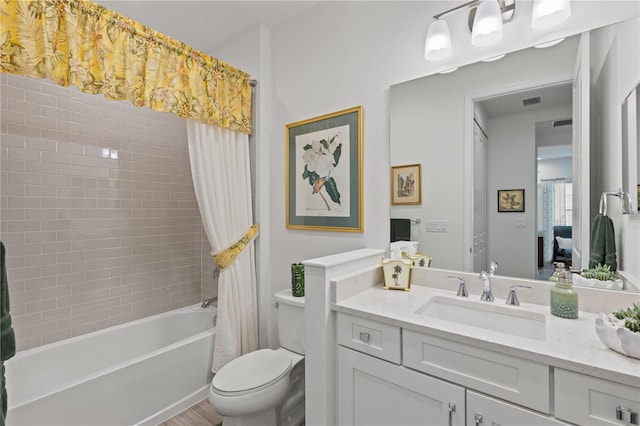 full bathroom with vanity, toilet, and shower / bath combo with shower curtain