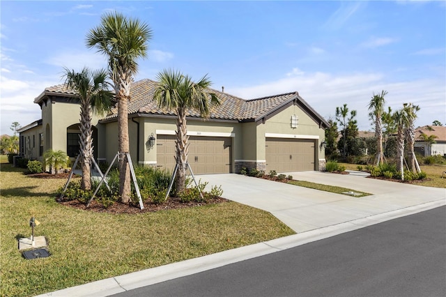 mediterranean / spanish-style home with a garage and a front lawn