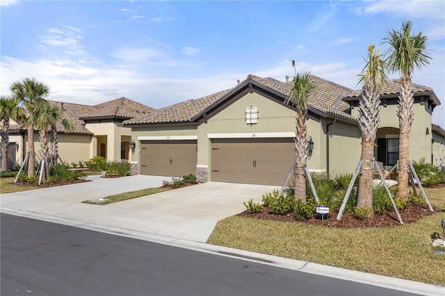 mediterranean / spanish-style home featuring a garage and a front lawn