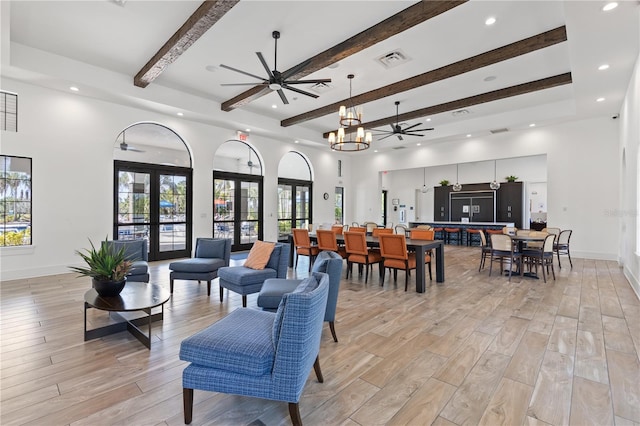 living room featuring light hardwood / wood-style flooring, ceiling fan, a high ceiling, french doors, and beamed ceiling