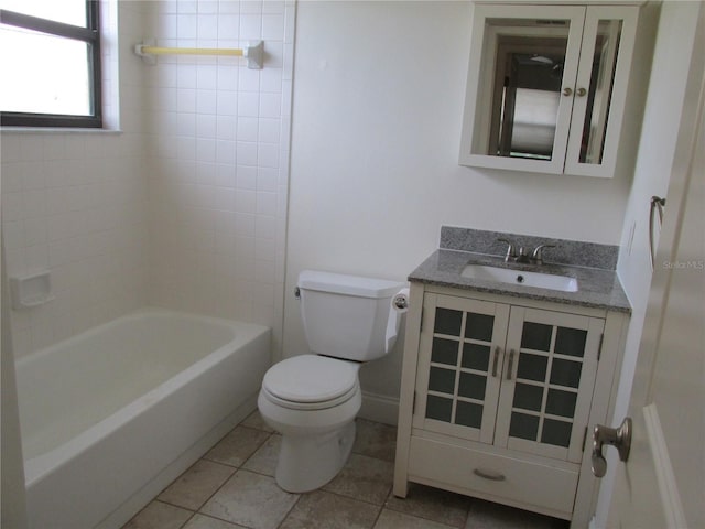 full bathroom featuring tiled shower / bath, tile patterned floors, toilet, and vanity