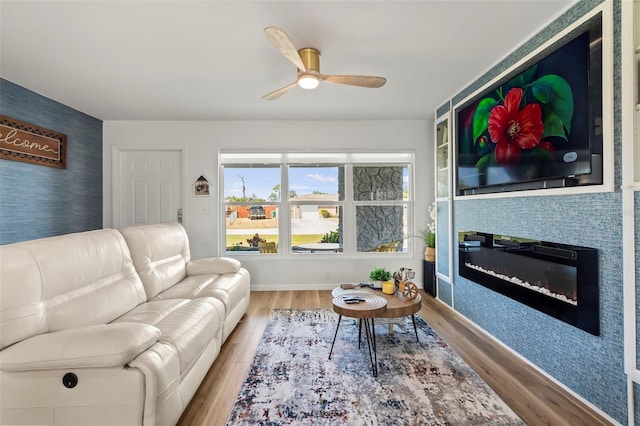 living room featuring ceiling fan and light wood-type flooring