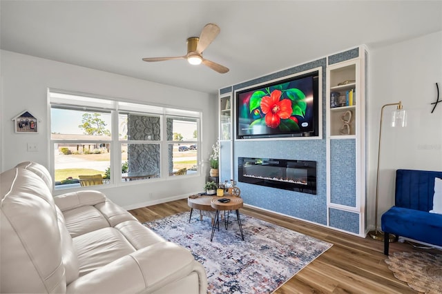 living room featuring hardwood / wood-style floors, a fireplace, and ceiling fan