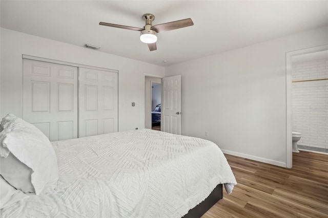 bedroom featuring ceiling fan, wood-type flooring, ensuite bathroom, and a closet