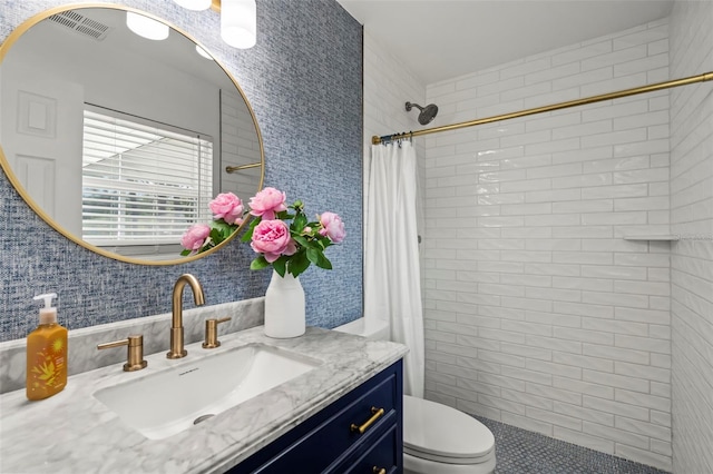 bathroom with vanity, toilet, and a shower with shower curtain