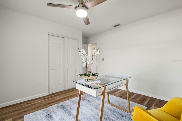 office featuring dark wood-type flooring and ceiling fan