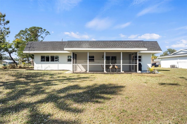 back of house featuring a sunroom, a yard, and central AC unit