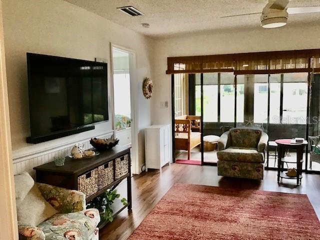 living room with hardwood / wood-style flooring and a textured ceiling