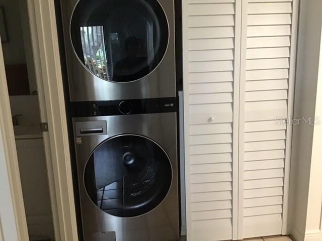 washroom featuring stacked washer / drying machine