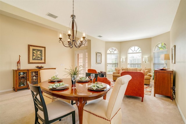 carpeted dining room with a notable chandelier