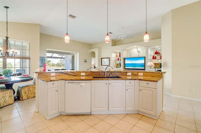 kitchen featuring sink, stone countertops, decorative light fixtures, white dishwasher, and white cabinets