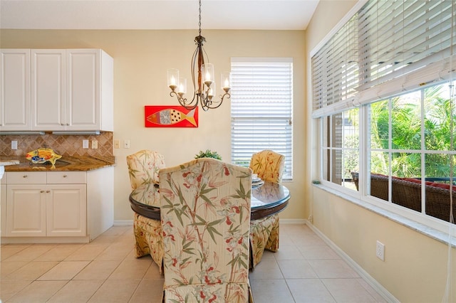 dining area featuring plenty of natural light, a chandelier, and light tile patterned flooring