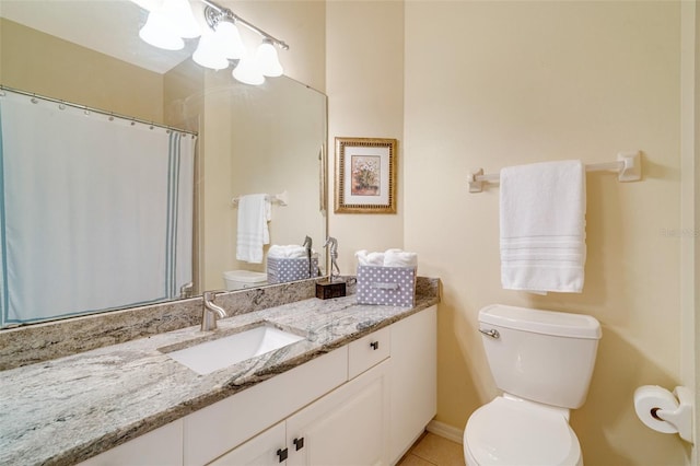 bathroom with tile patterned floors, vanity, and toilet