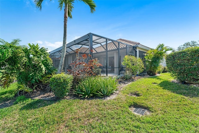 view of yard with glass enclosure