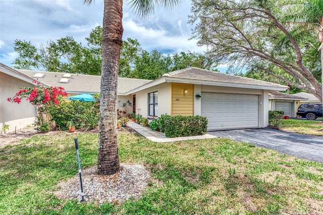 ranch-style home featuring a garage and a front yard