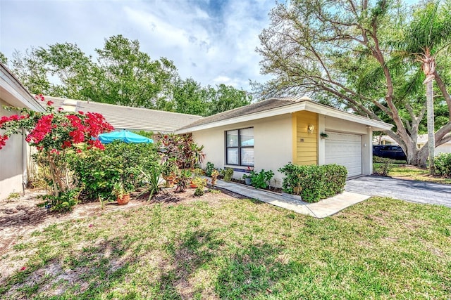 single story home with a garage and a front yard