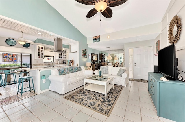 living room with sink, high vaulted ceiling, ceiling fan, and light tile patterned flooring