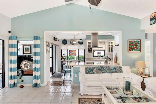 tiled living room featuring vaulted ceiling and ceiling fan