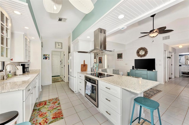 kitchen featuring sink, oven, white cabinets, island exhaust hood, and black electric stovetop