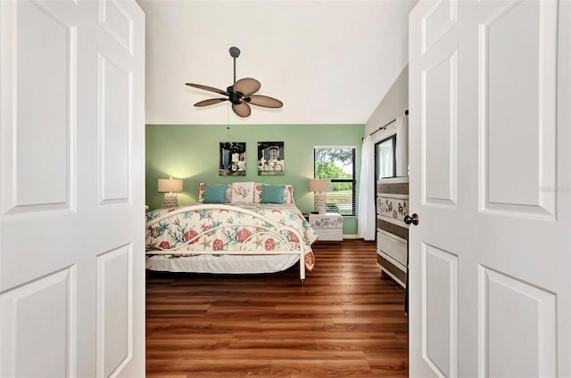 bedroom featuring ceiling fan, wood-type flooring, and vaulted ceiling