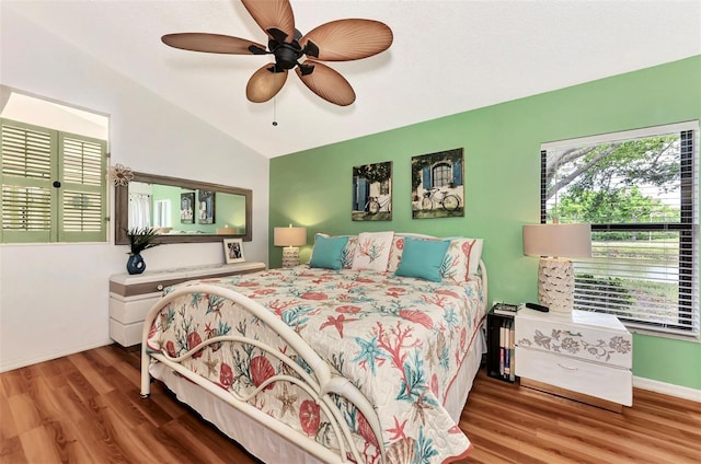 bedroom featuring hardwood / wood-style flooring, ceiling fan, and lofted ceiling