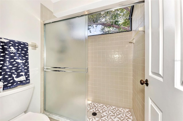 bathroom featuring toilet and walk in shower