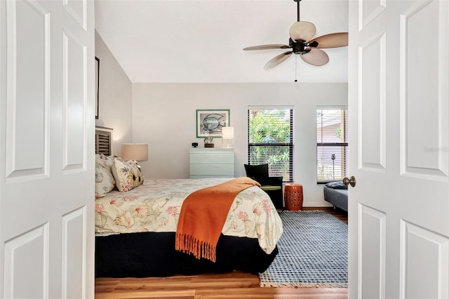 bedroom with ceiling fan and wood-type flooring