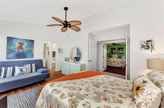 bedroom with vaulted ceiling, ceiling fan, ensuite bathroom, and hardwood / wood-style floors