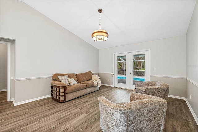 living room featuring vaulted ceiling, wood-type flooring, and french doors