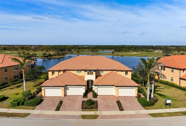 view of front of home with a garage and a water view