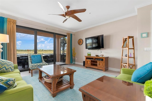 living room with ornamental molding and ceiling fan