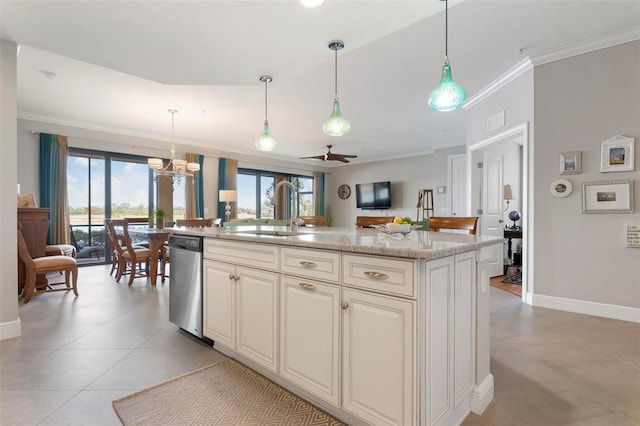 kitchen with hanging light fixtures, ornamental molding, sink, and a center island with sink