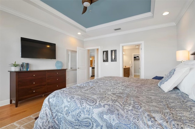 bedroom with a raised ceiling, crown molding, ceiling fan, and light wood-type flooring