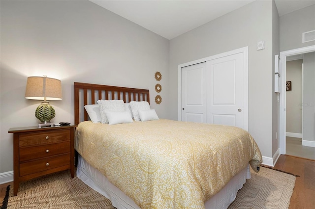 bedroom featuring hardwood / wood-style flooring and a closet