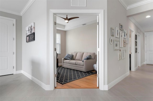 hallway featuring light tile patterned flooring and crown molding