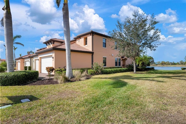 view of property exterior featuring a water view, a garage, and a lawn