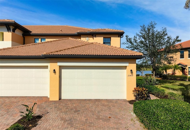 mediterranean / spanish home featuring a garage