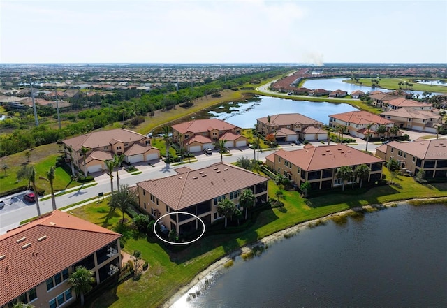 birds eye view of property with a water view