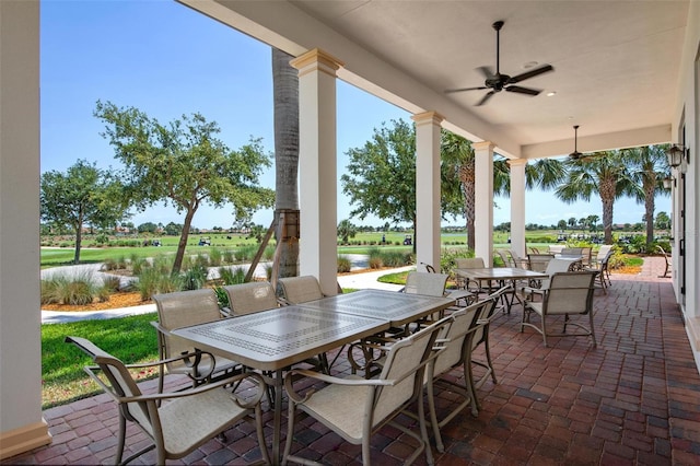 view of patio / terrace featuring a water view and ceiling fan