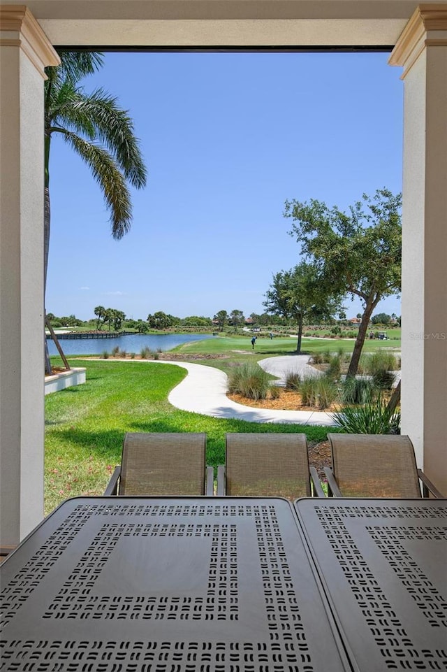 exterior space featuring a water view and a lawn