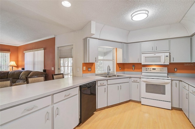 kitchen featuring sink, white cabinets, white appliances, and light hardwood / wood-style flooring