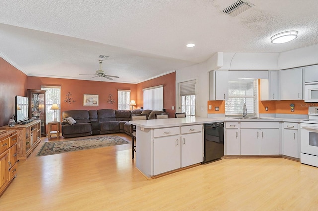 kitchen featuring white cabinetry, light hardwood / wood-style flooring, white appliances, and kitchen peninsula