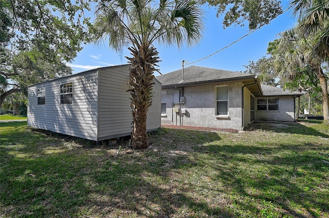 rear view of property featuring a lawn