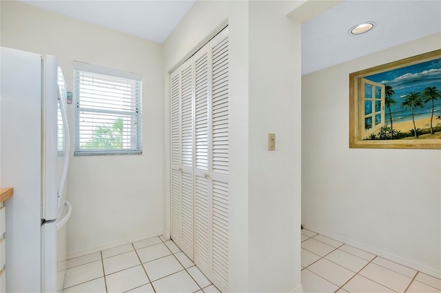 corridor featuring light tile patterned flooring