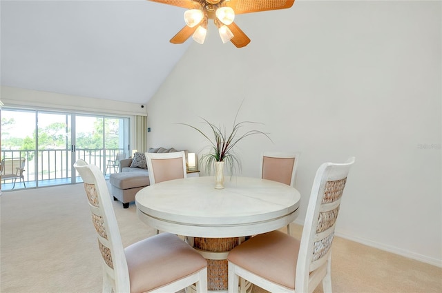 carpeted dining room with high vaulted ceiling