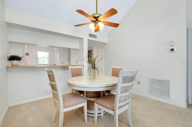 dining area featuring vaulted ceiling, light colored carpet, and ceiling fan