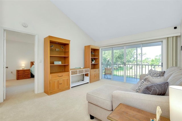 carpeted living room with high vaulted ceiling