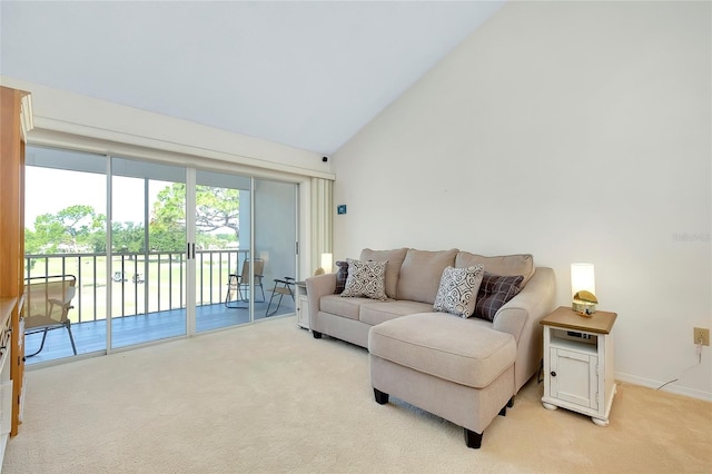 carpeted living room with high vaulted ceiling