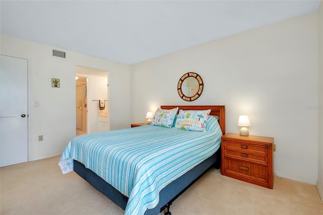 carpeted bedroom with connected bathroom