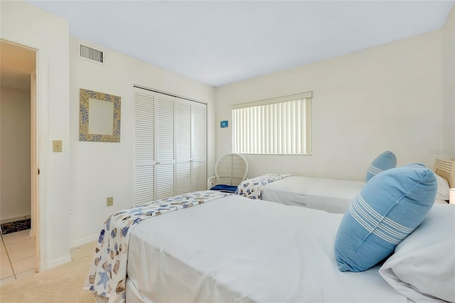 bedroom with light colored carpet and a closet